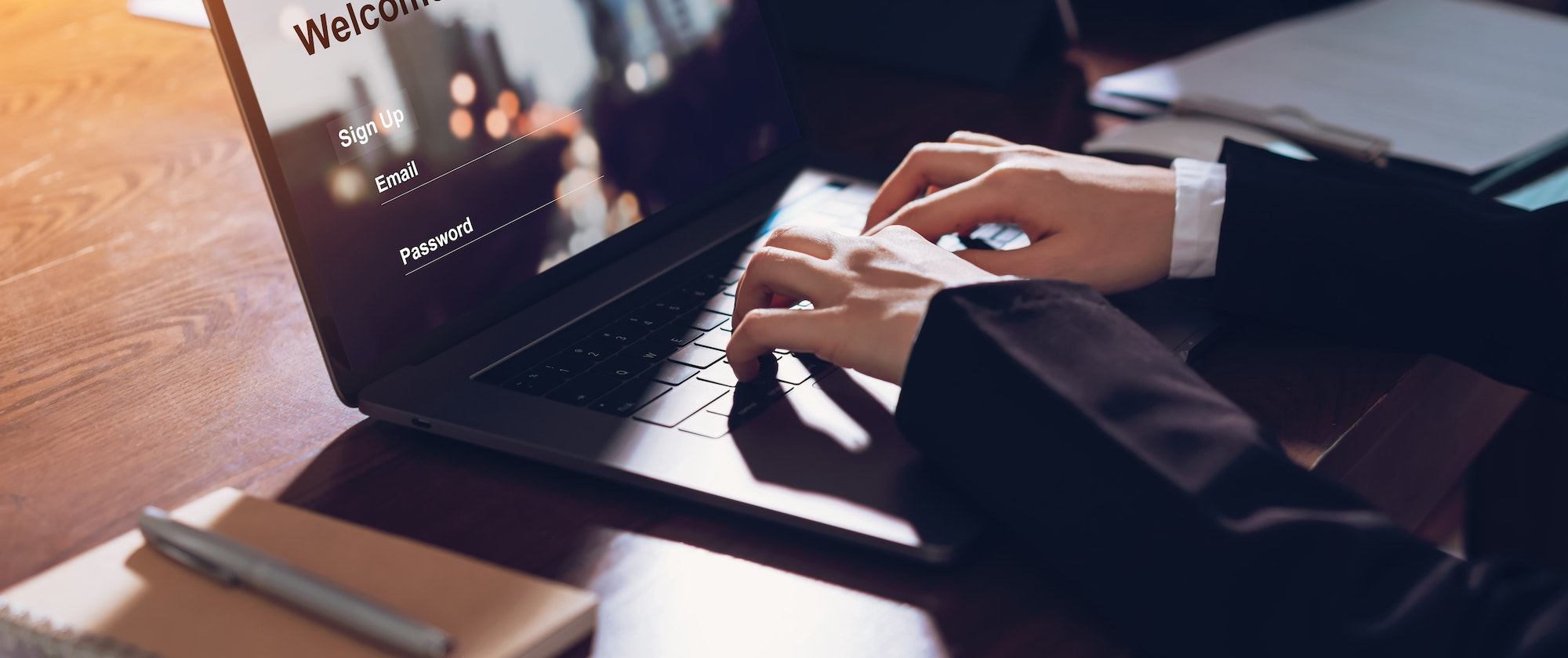 Business woman hands typing on laptop computer with sign up and password to online website.