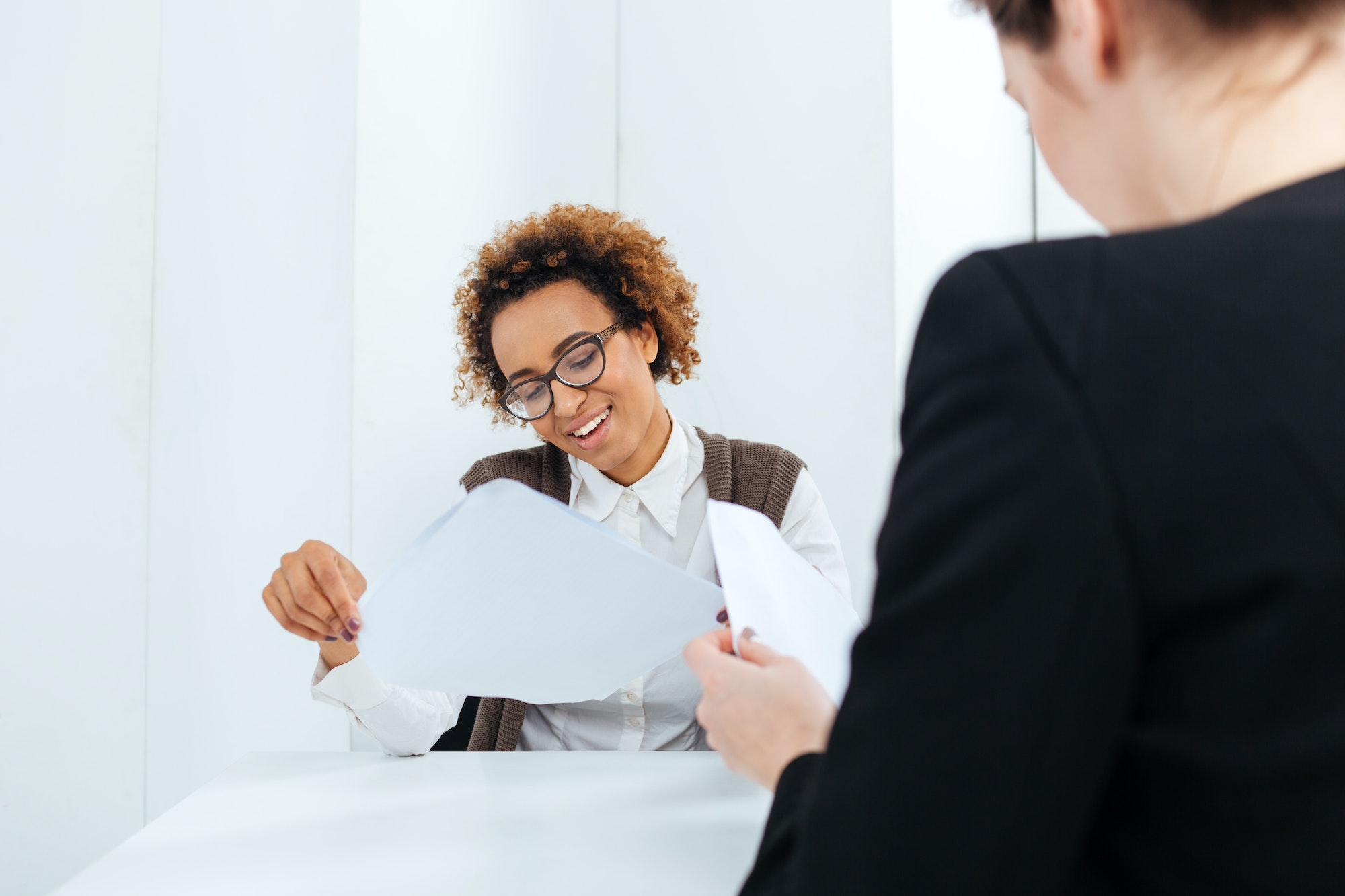 Smiling african american businesswoman having job interview and filling application